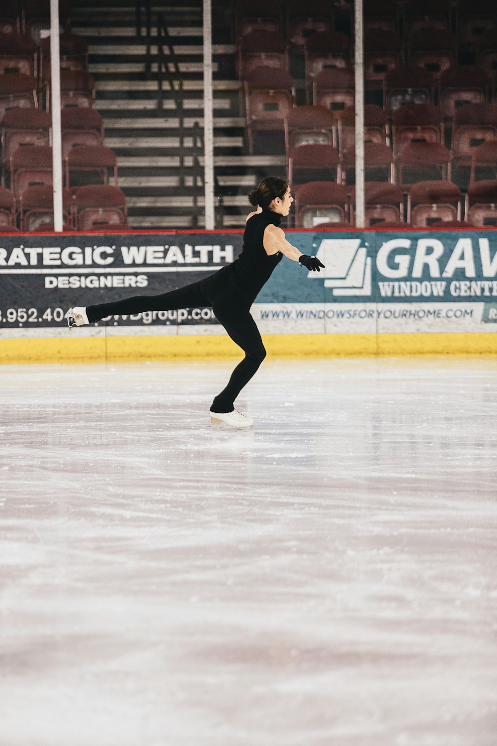 man in black shirt and pants playing ice hockey