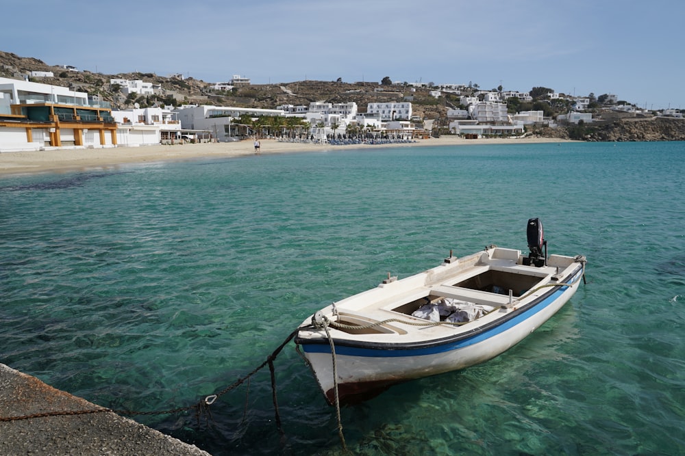 white and blue boat on sea during daytime