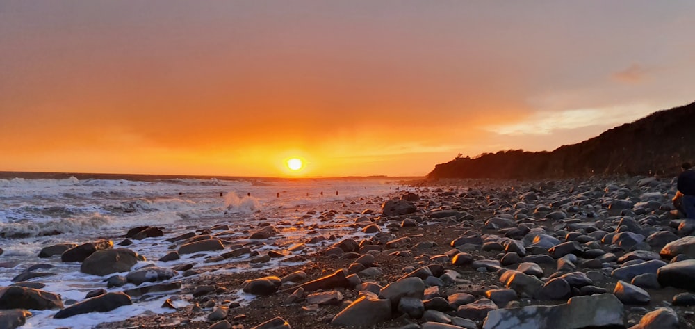 rocky shore during sunset with sunset