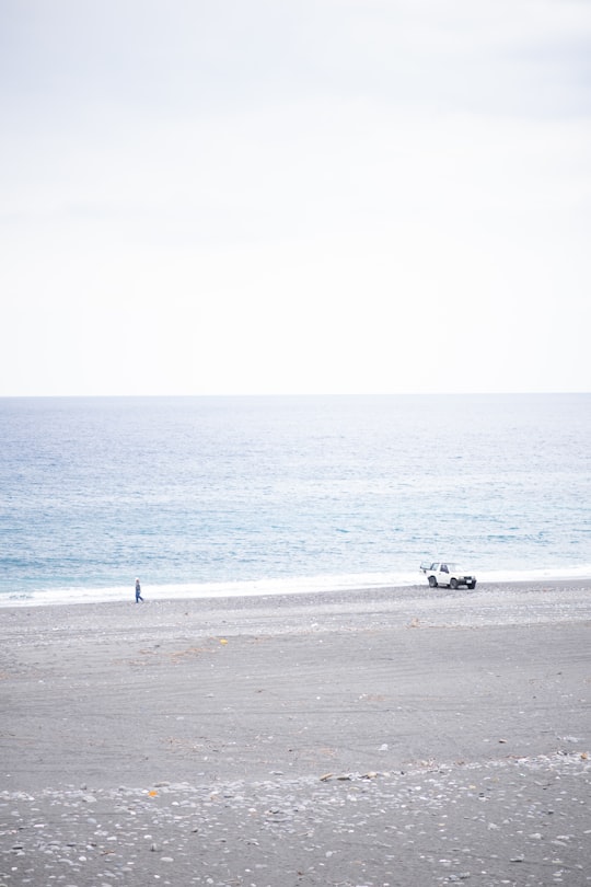 white and black motor scooter on gray concrete road in Hualien City Taiwan