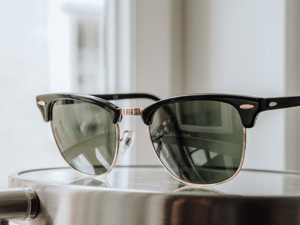 black framed sunglasses on brown wooden table