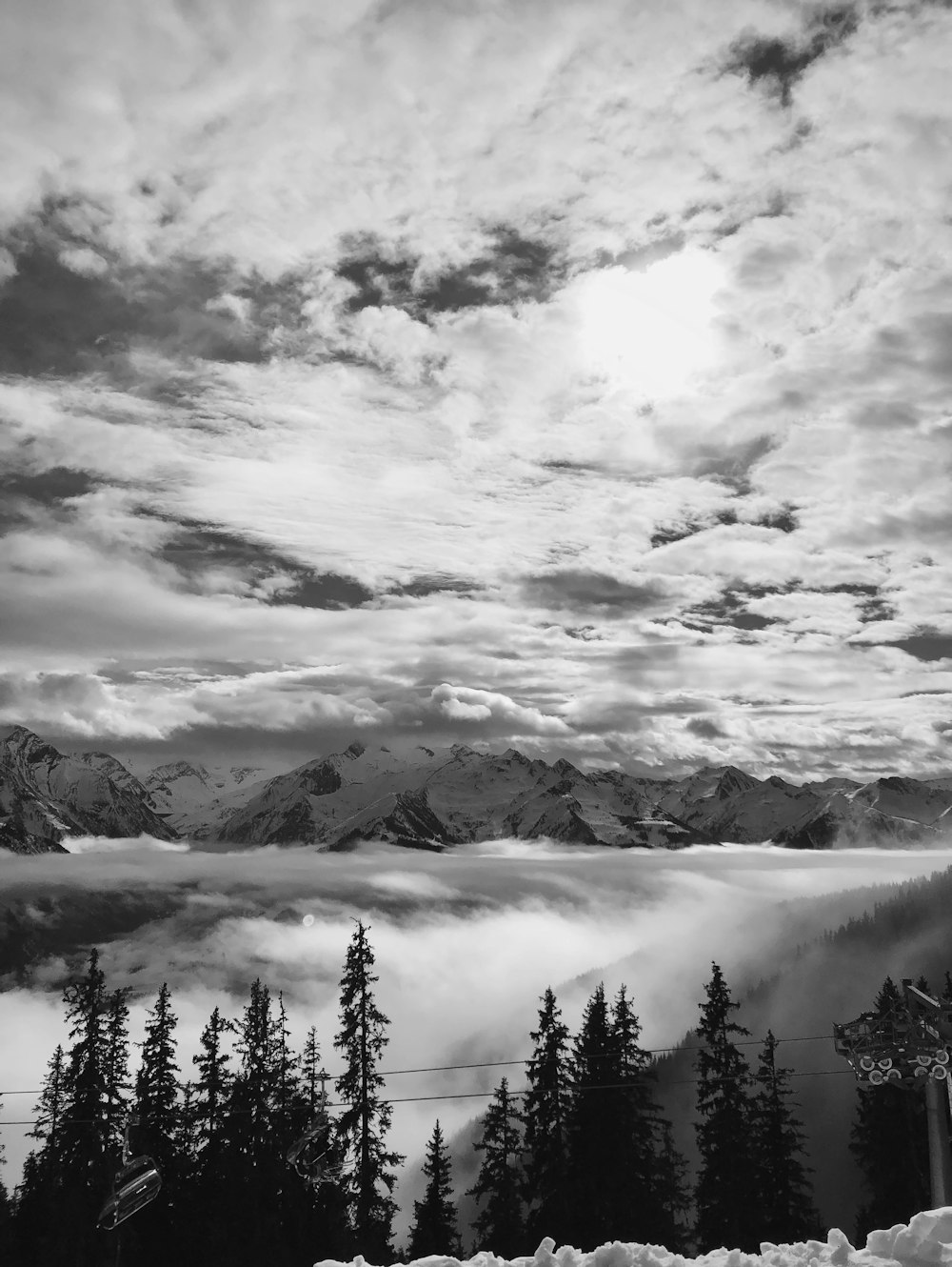 grayscale photo of mountains and clouds