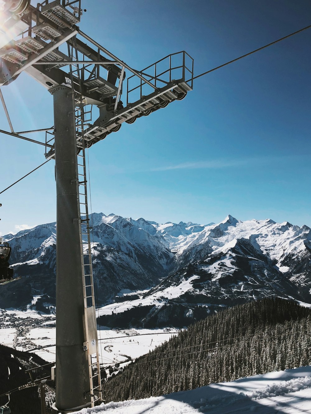 cable cars over snow covered mountain