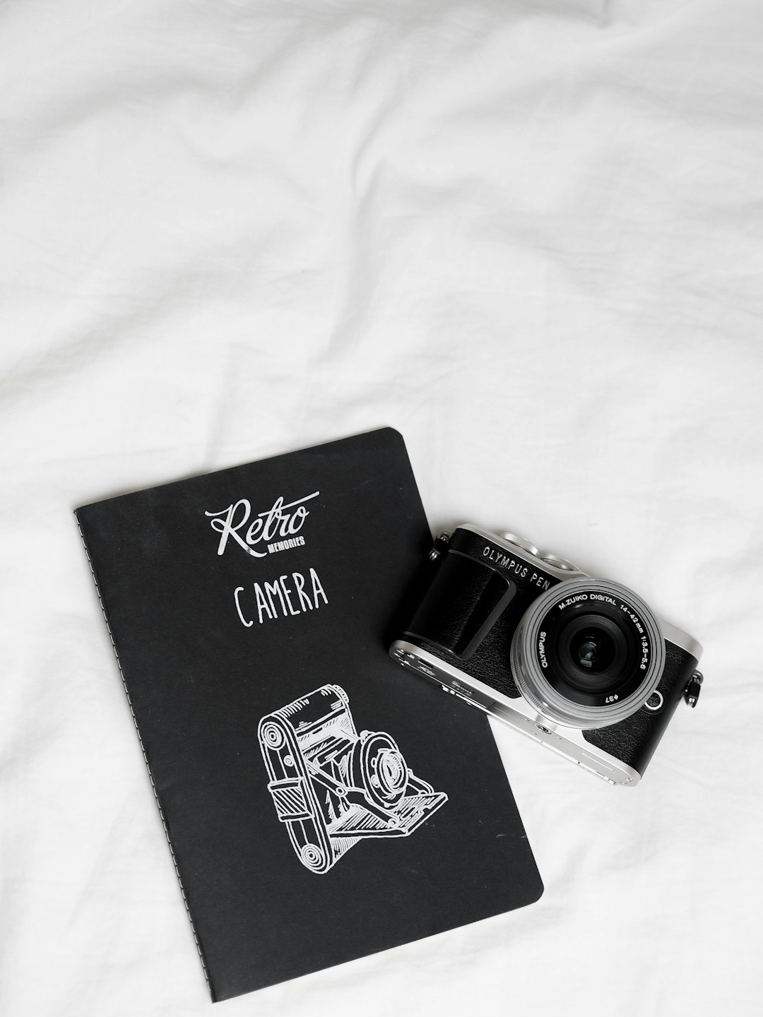 black and silver camera on black book