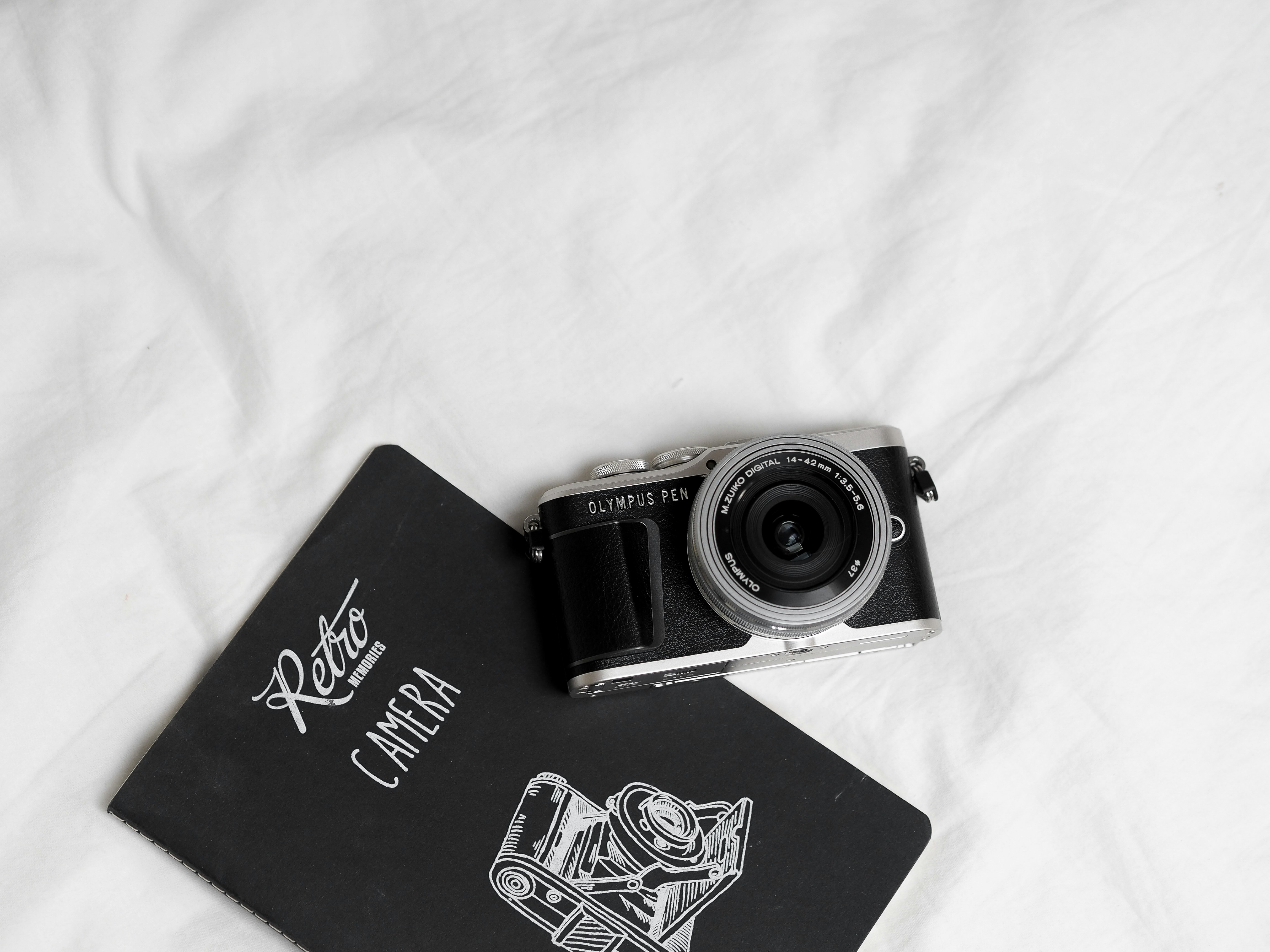 black and silver camera on black book