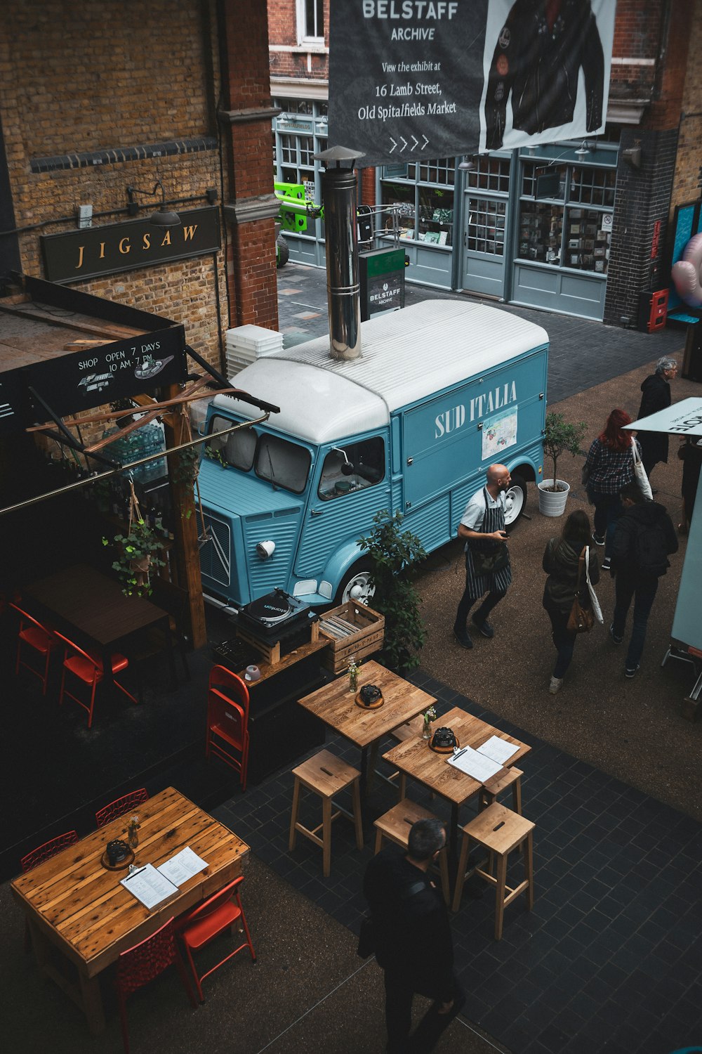 a blue and white truck parked in front of a building