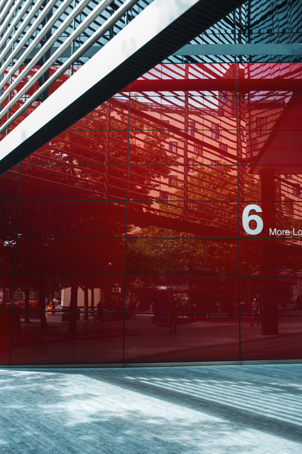 a red glass building with the number six on it