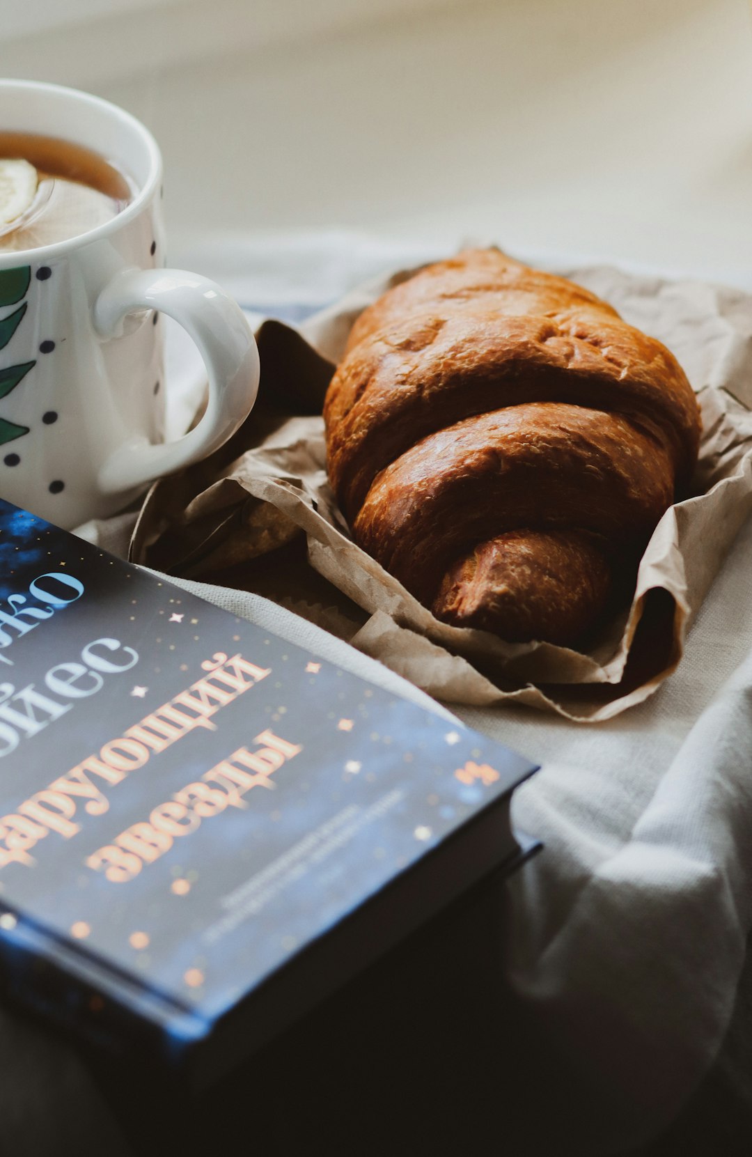 white ceramic mug beside brown bread