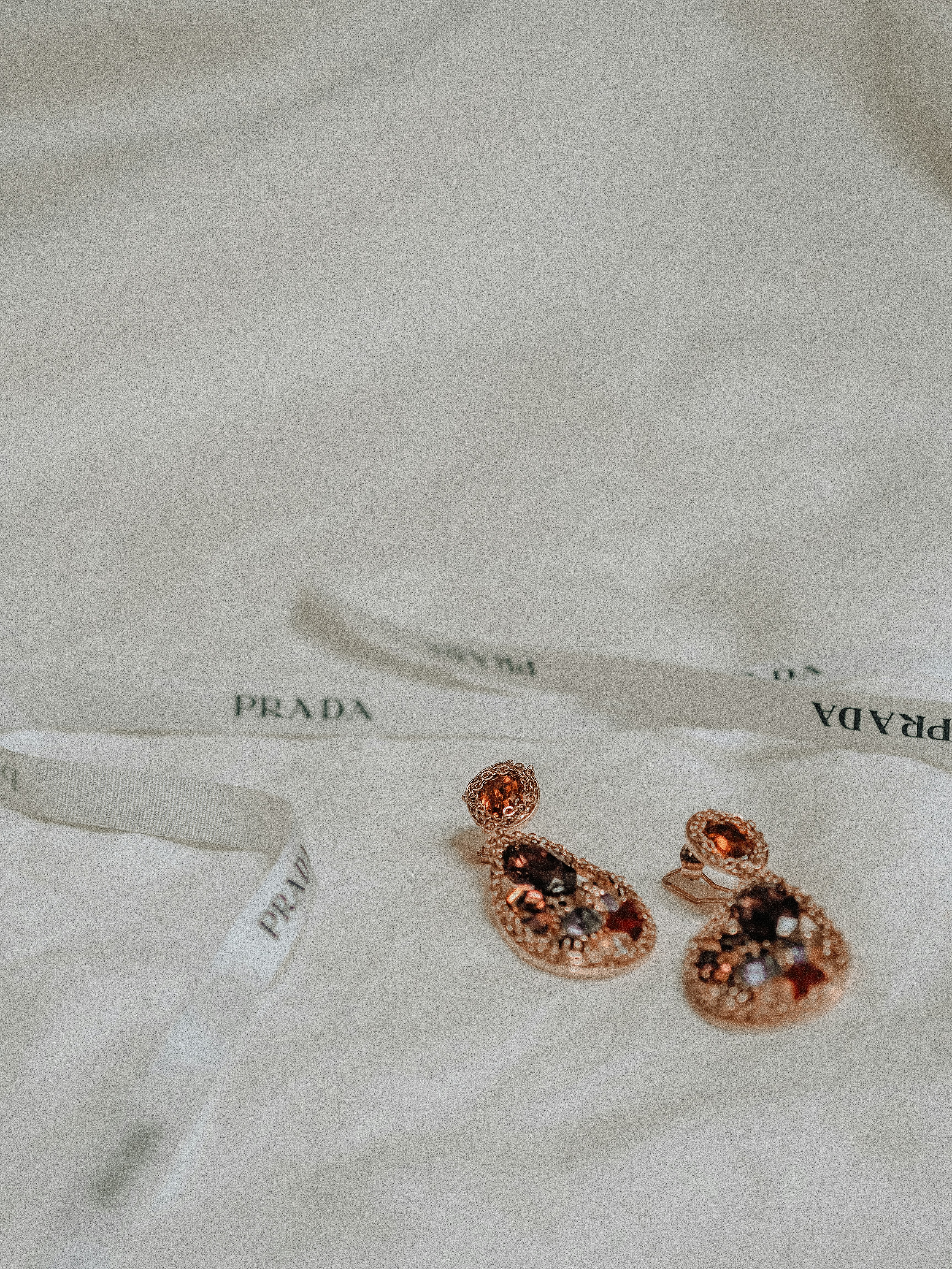 silver and brown beads on white textile