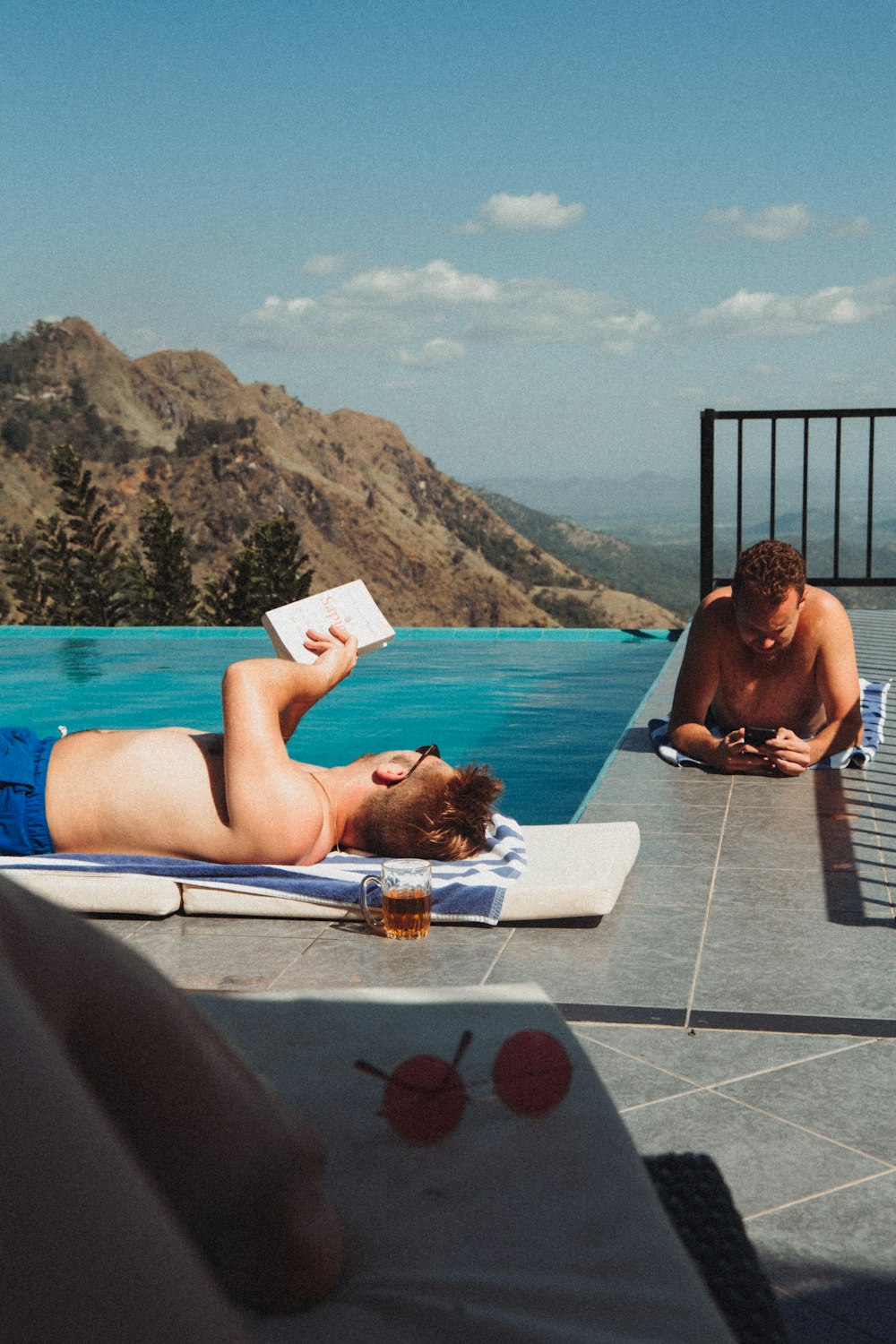 man lying on blue and white towel on blue and white towel on blue and white