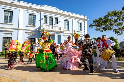 people in green and pink dress dancing on street during daytime colombia google meet background