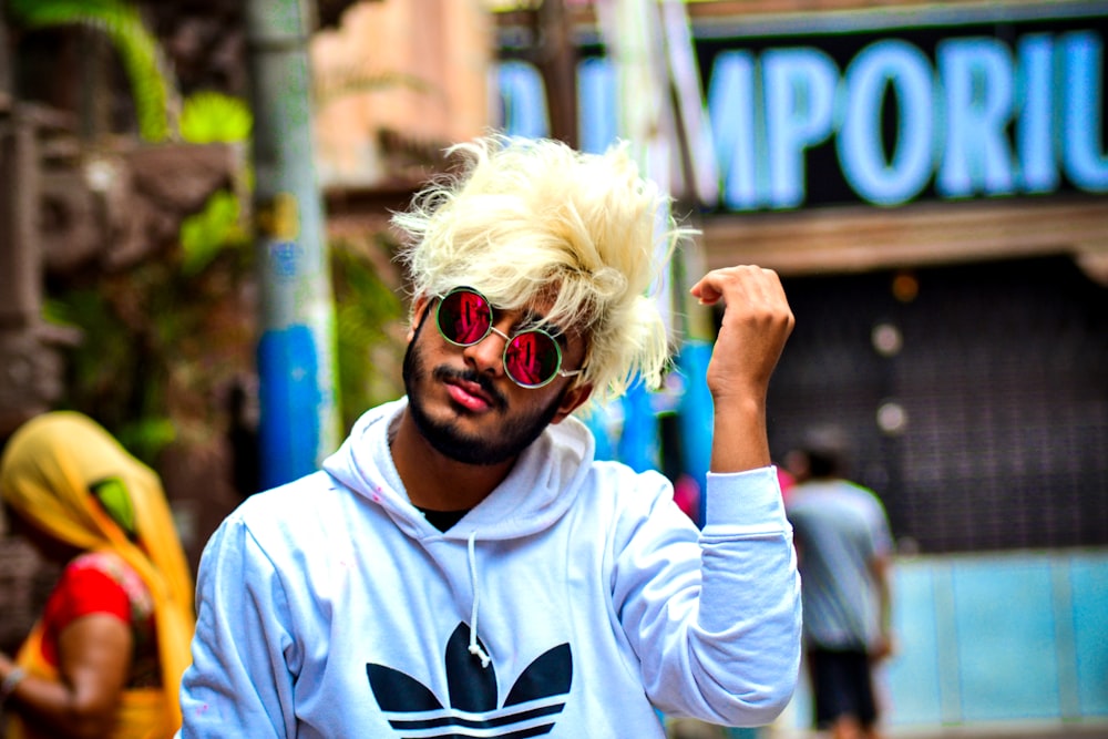 woman in white adidas hoodie wearing sunglasses