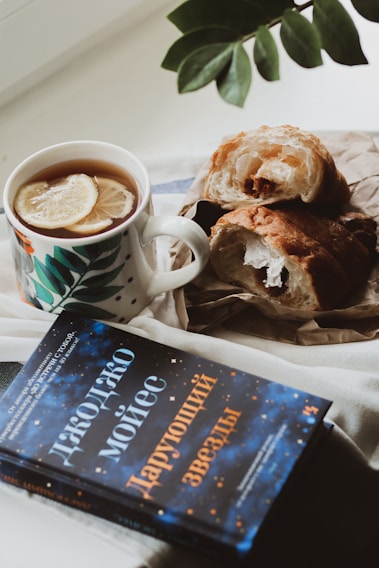 A cozy cafe setting with a steaming cup of tea and a plate of corn cheese sandwiches.