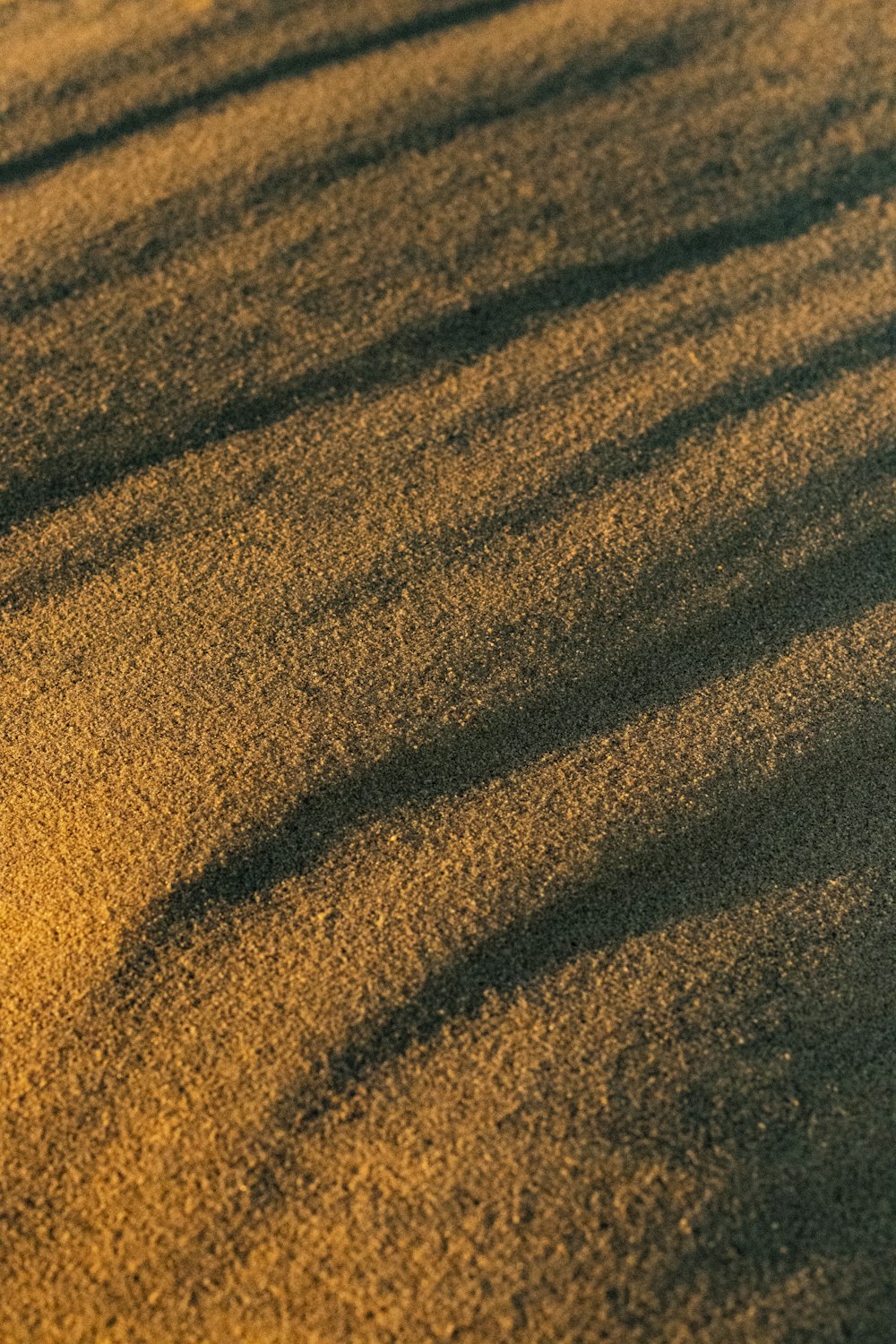 brown and black sand during daytime