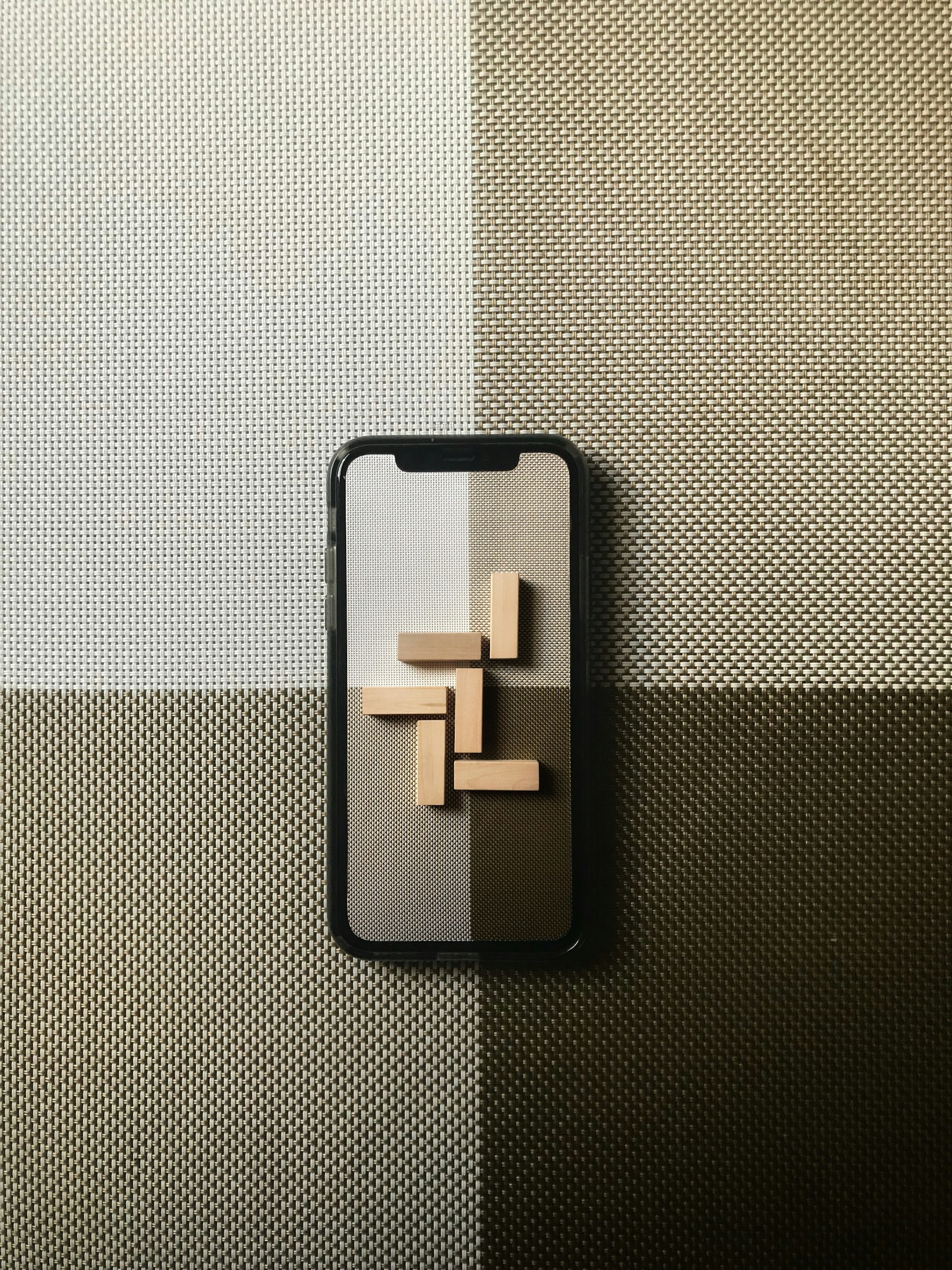 black iphone case on gray textile