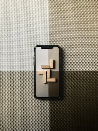 black iphone case on gray textile