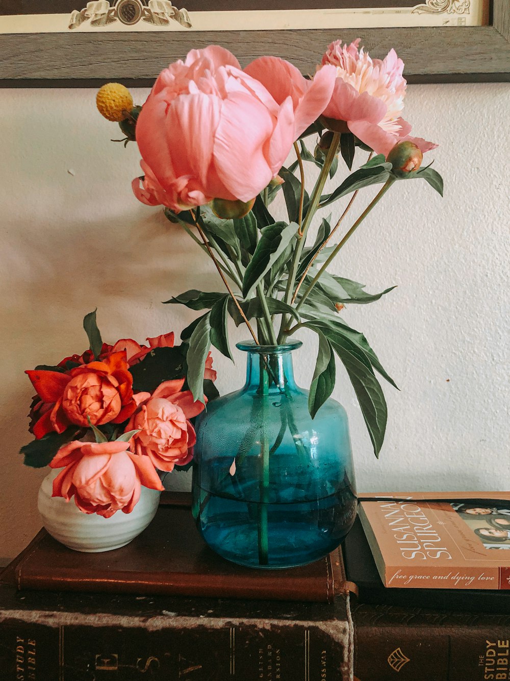 pink roses in blue glass vase
