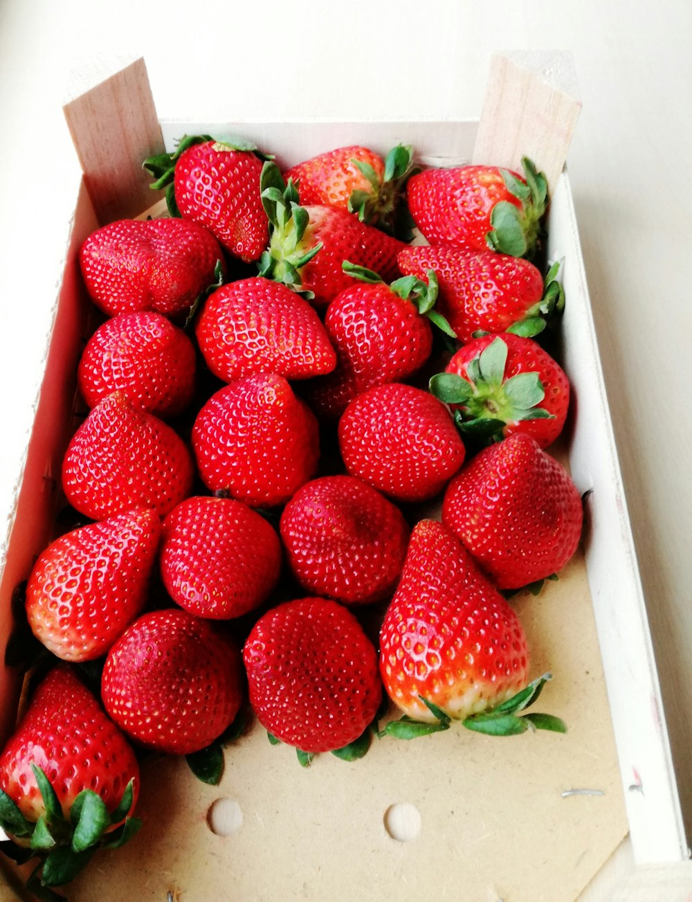 red strawberries in white box