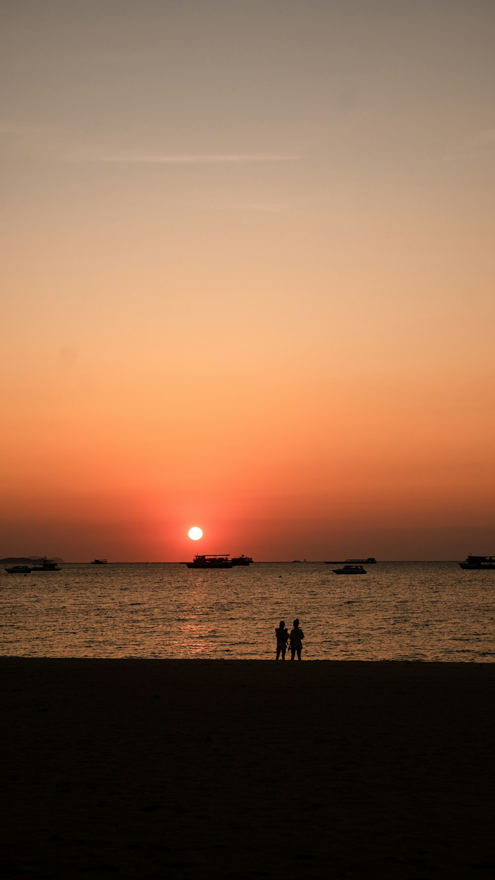 silhouette of people on beach during sunset