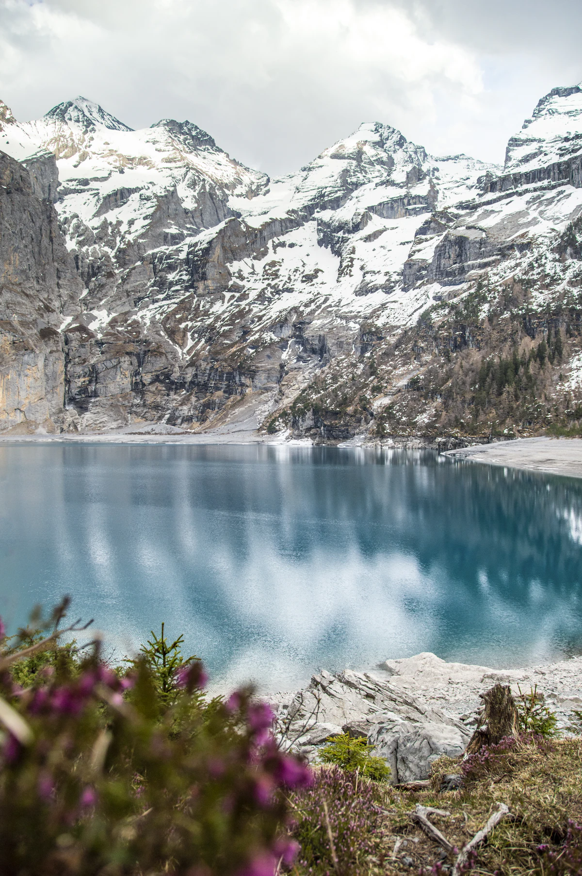 Turquoise lake between grey rocky mountains