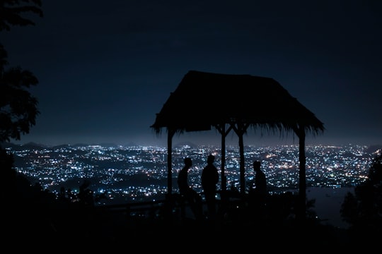 silhouette of people standing on beach during sunset in Lampung Indonesia