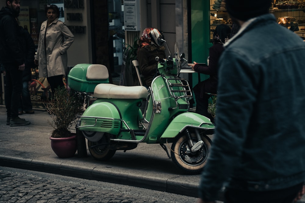 green and black motor scooter on road during daytime