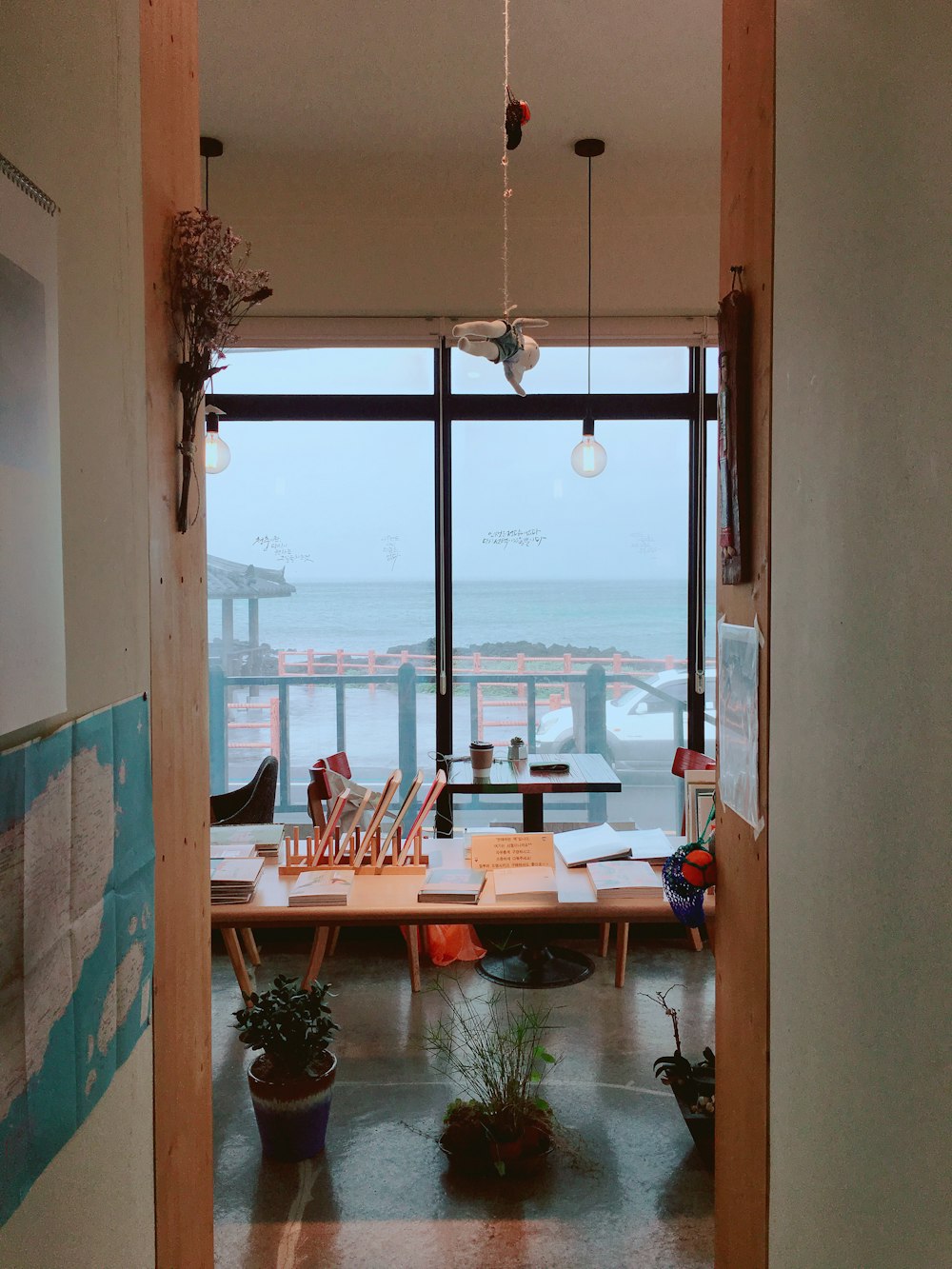 brown wooden table near glass window