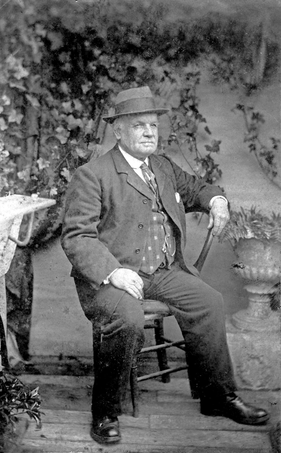 man in black suit sitting on chair