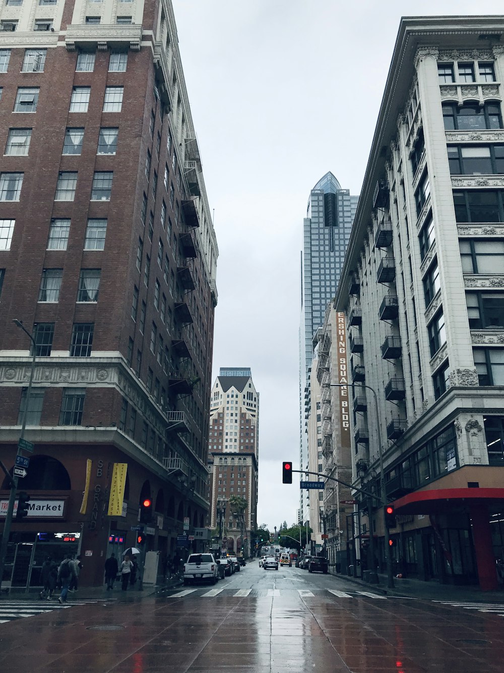 people walking on street between high rise buildings during daytime