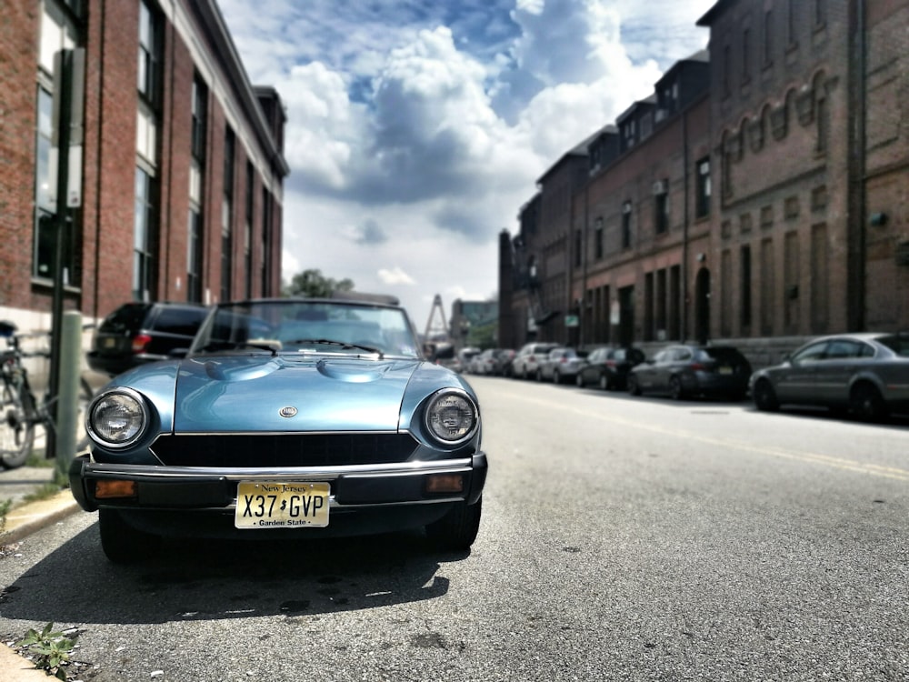 blue bmw car parked on street during daytime