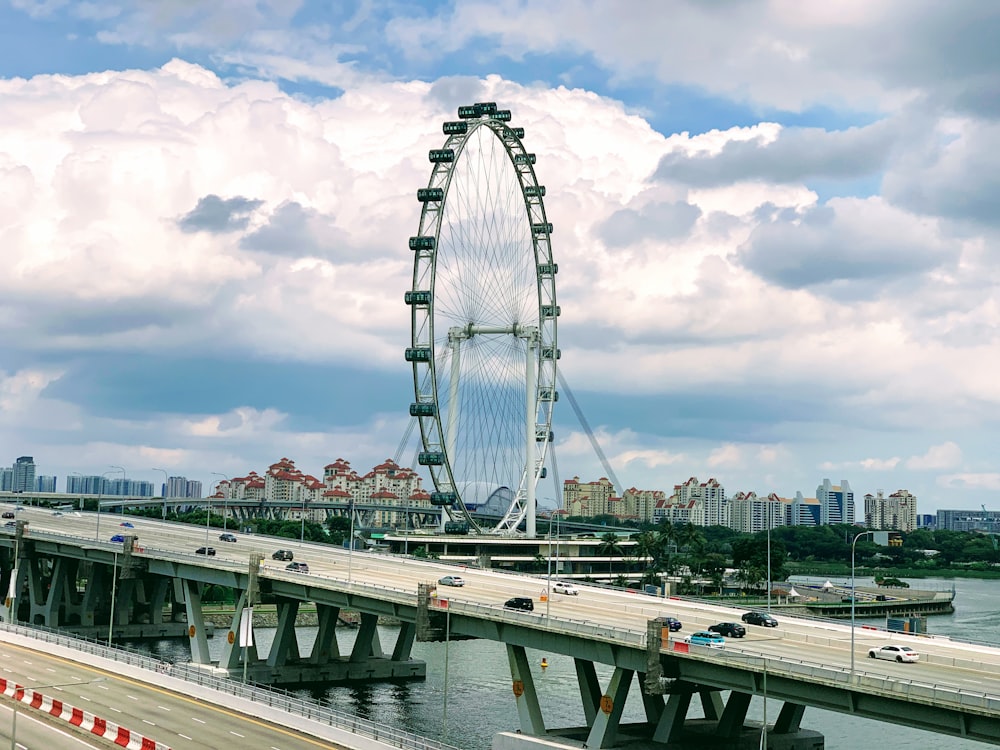 white bridge over body of water under cloudy sky during daytime