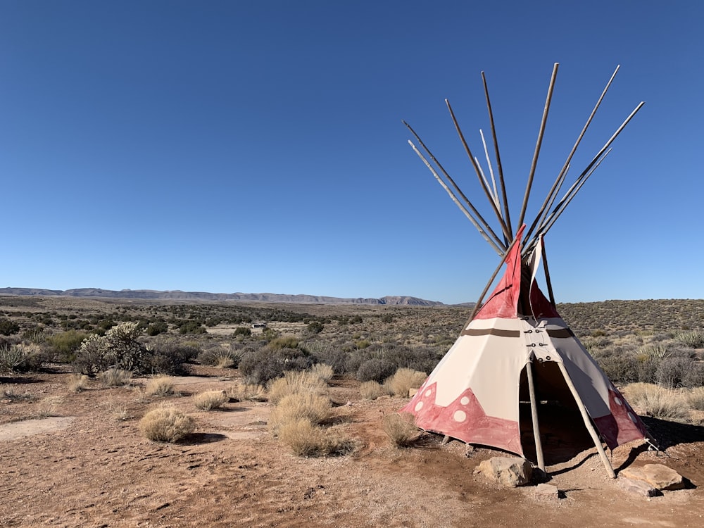 brown tent on brown field under blue sky during daytime