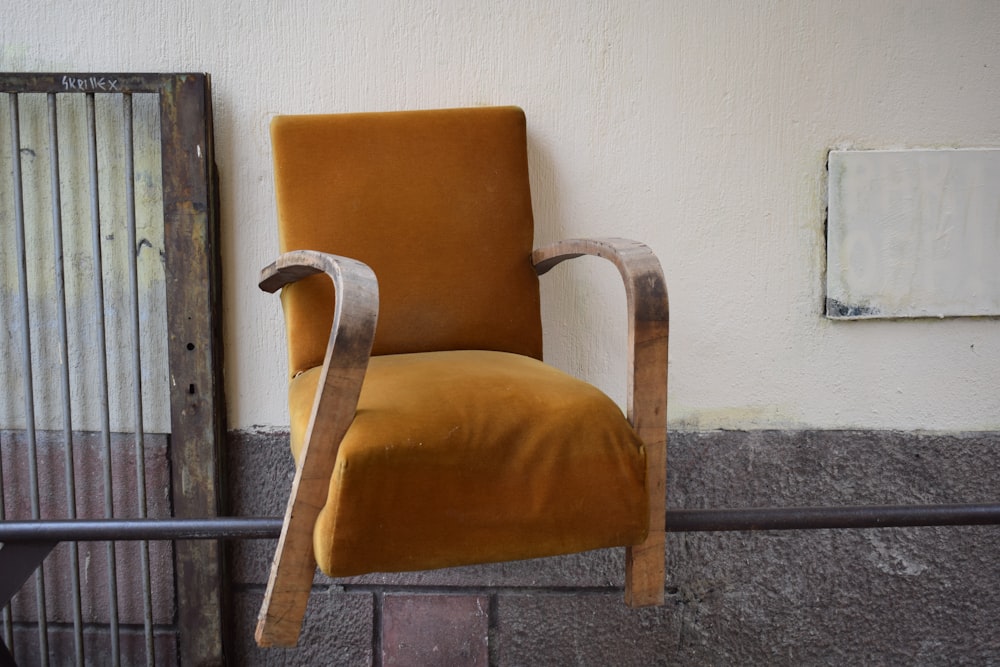 brown wooden framed brown padded armchair