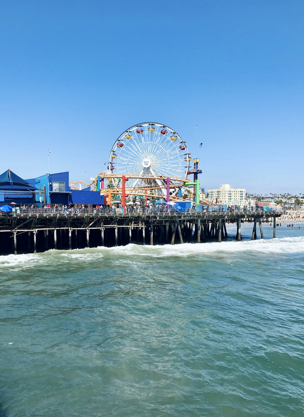 ferris wheel near body of water during daytime