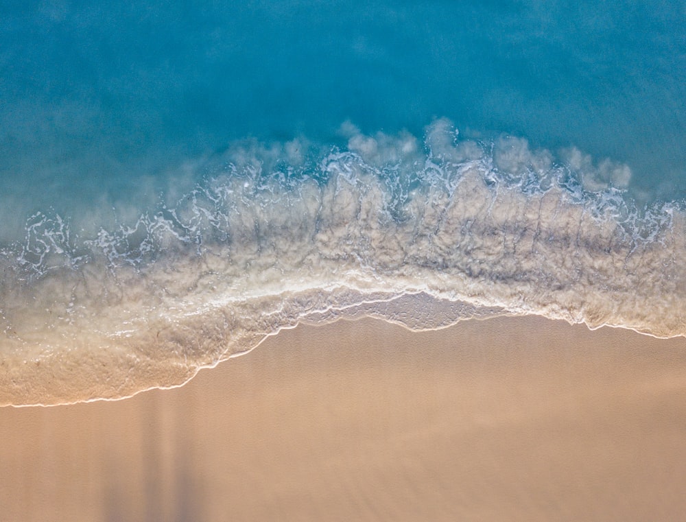 water waves on shore during daytime