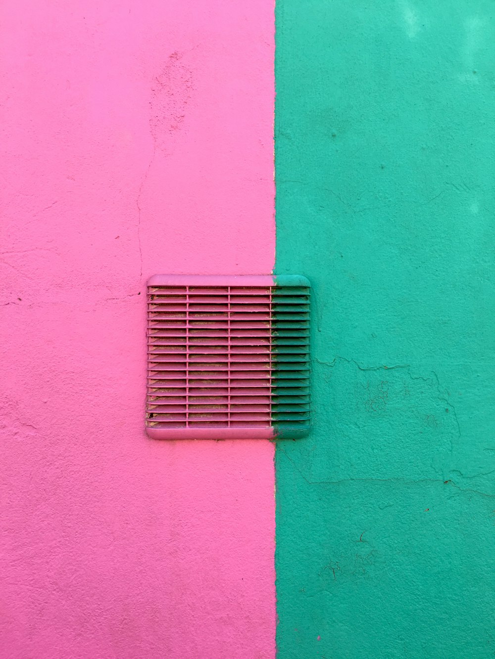 blue metal window frame on green concrete wall