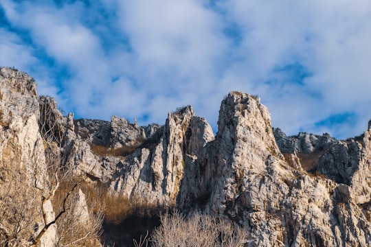 brown rocky mountain under white clouds and blue sky during daytime in Gara Bov Bulgaria