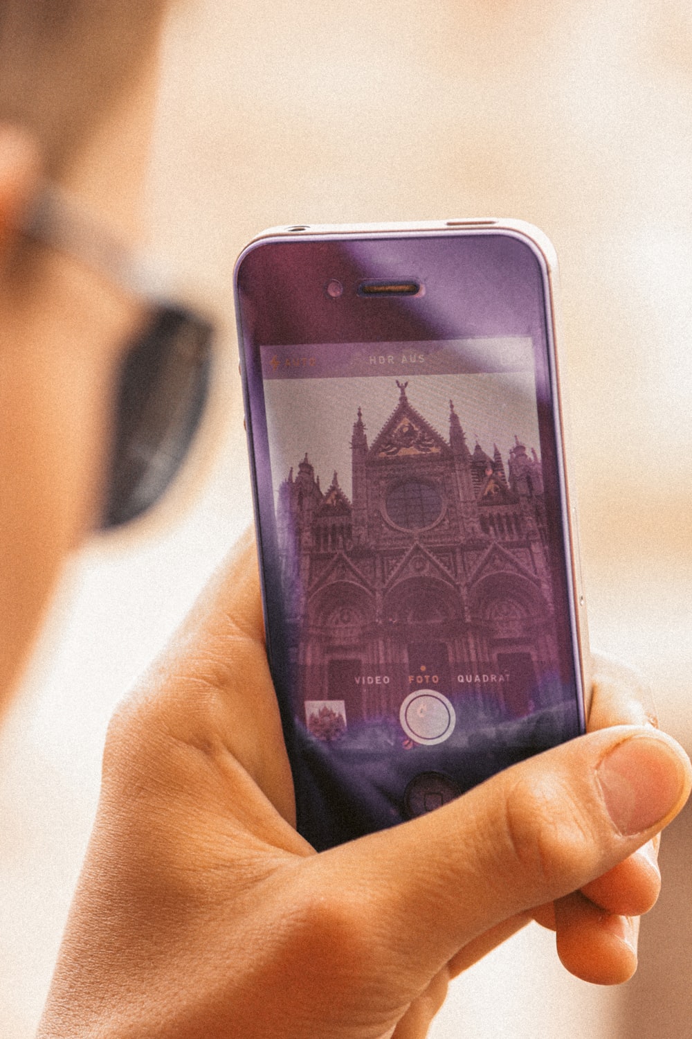 person holding iphone 6 with purple case