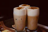 An inviting Asian dolce coffee with layers of milk and espresso, garnished with a sprinkle of cinnamon.