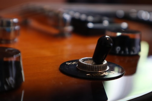 Detailed shot of guitar electronics being carefully rewired.