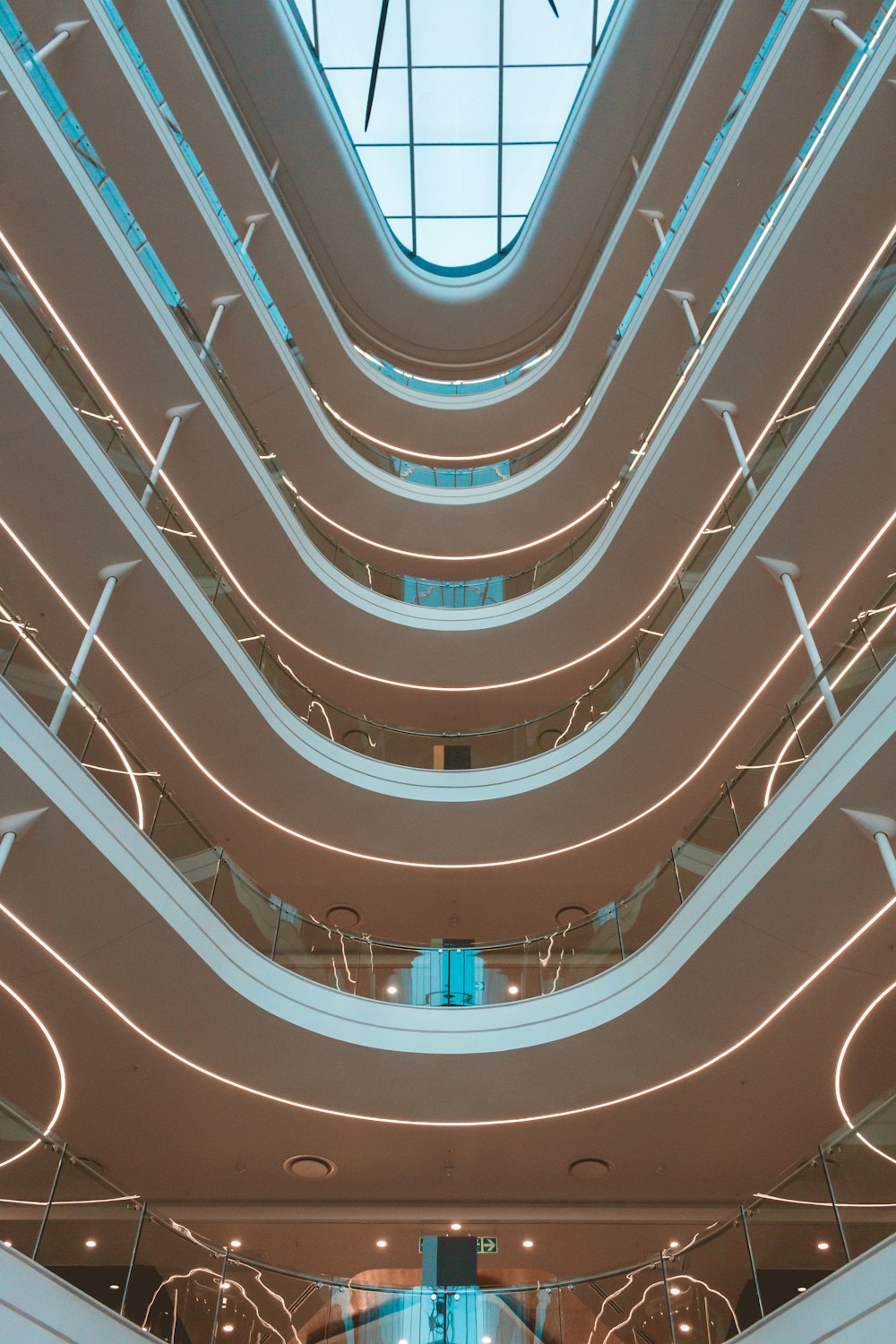 white spiral staircase with red ceiling light