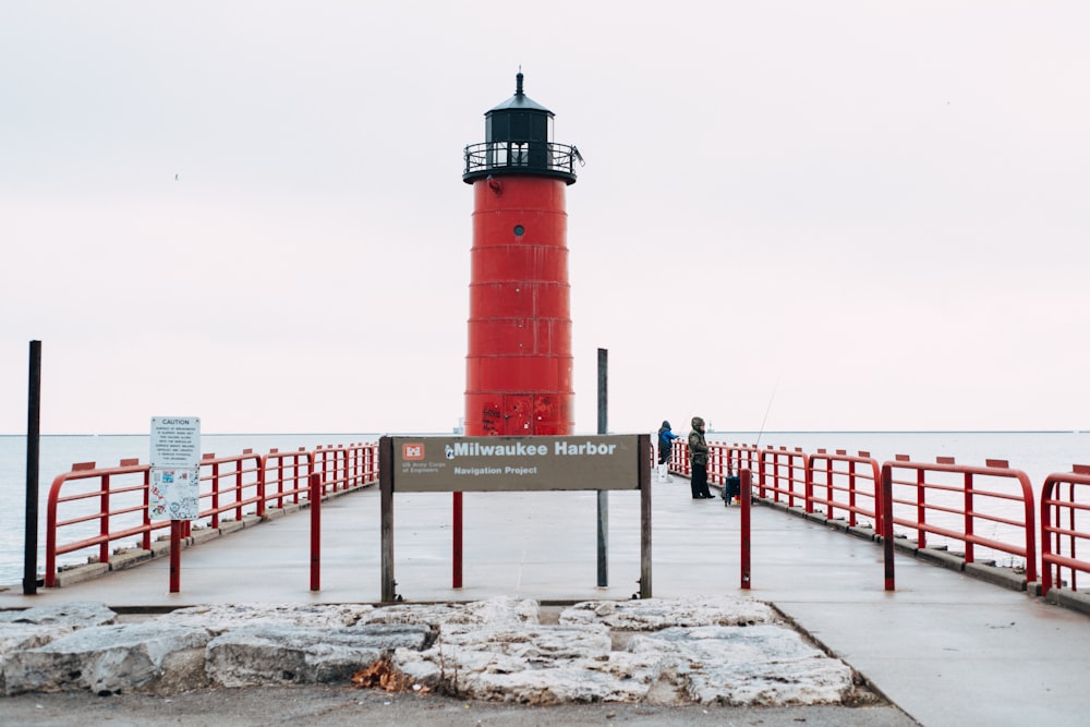 Faro rojo y blanco cerca del mar durante el día