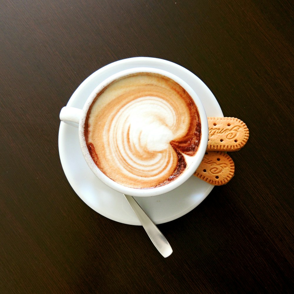 white ceramic mug with cappuccino