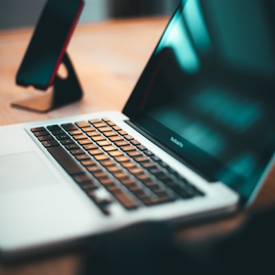 macbook pro on brown wooden table