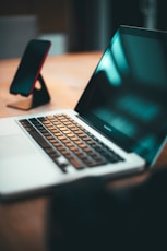 macbook pro on brown wooden table