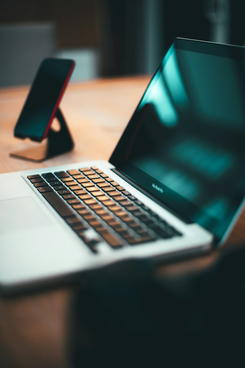 macbook pro on brown wooden table