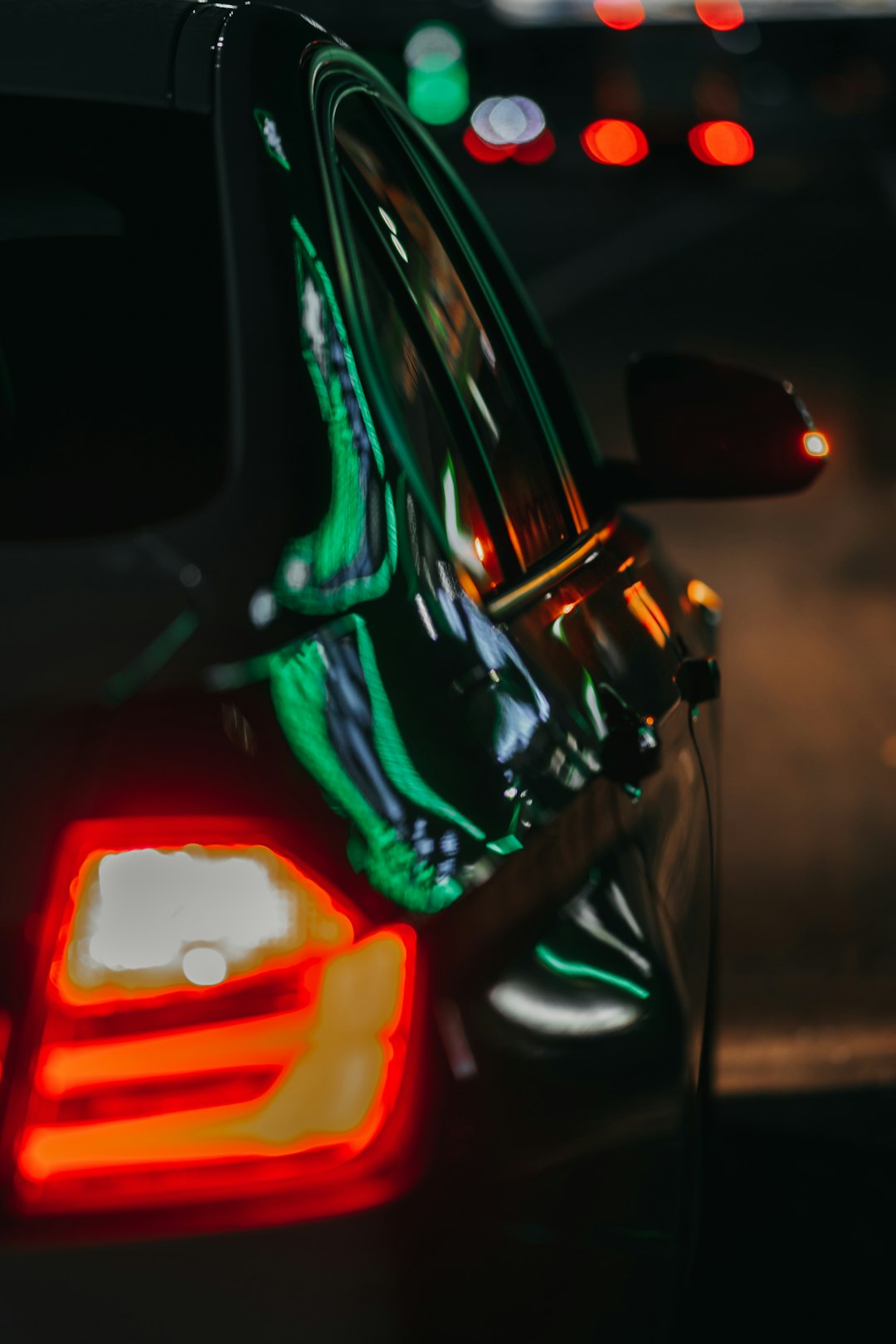 black and red car on road during night time