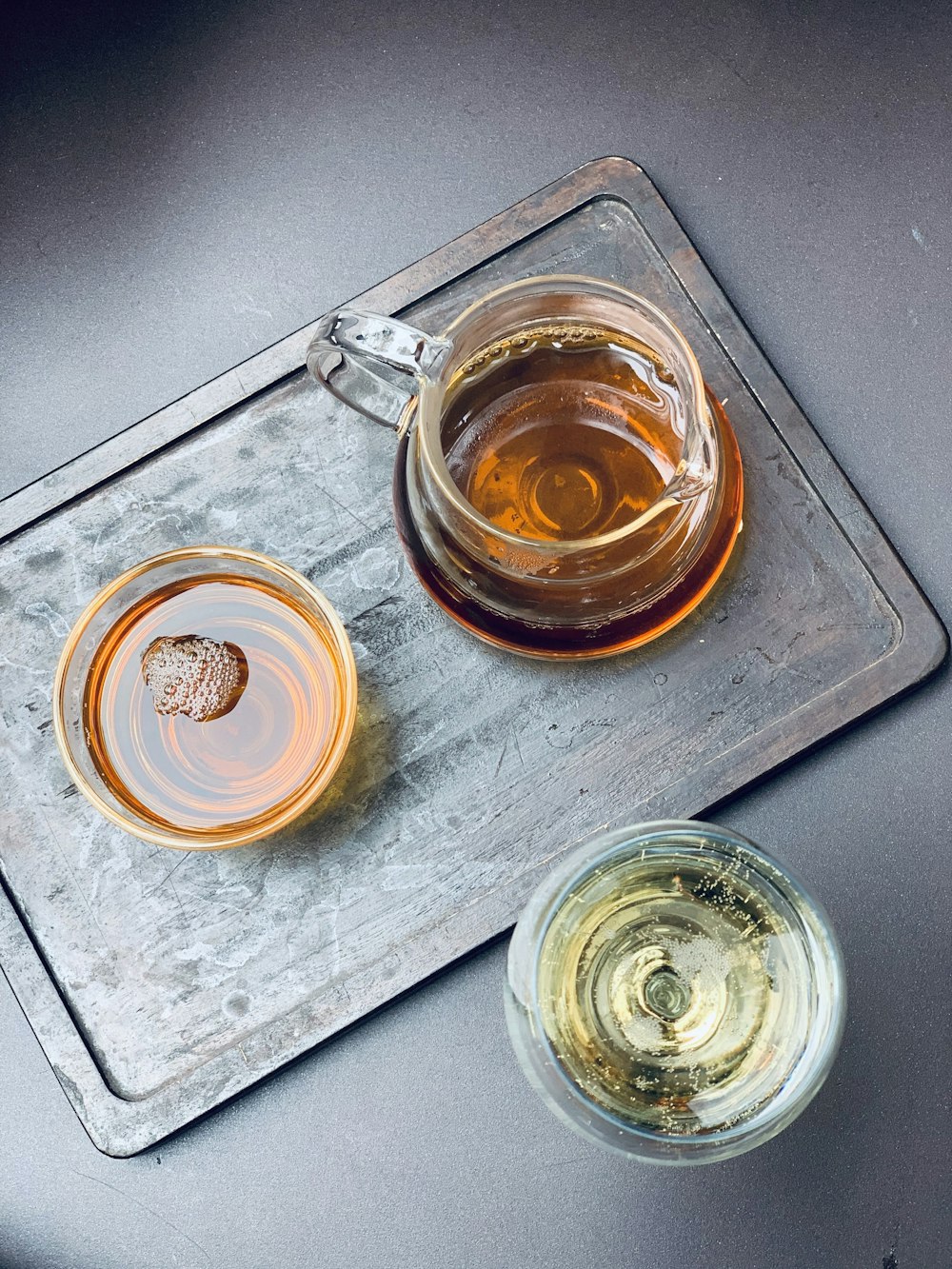 clear glass mug on stainless steel tray