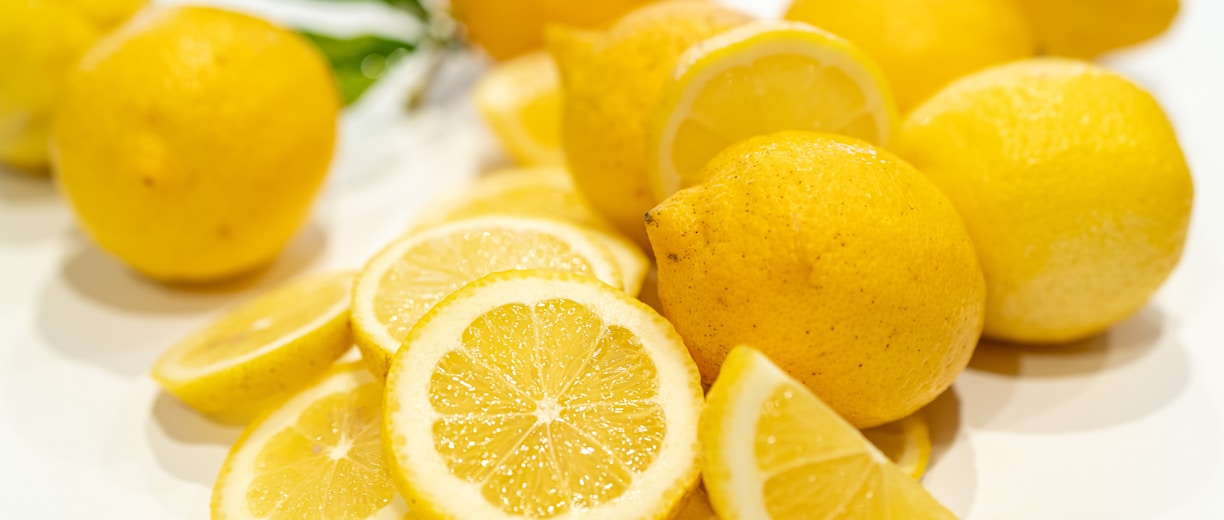 yellow lemon fruits on white surface