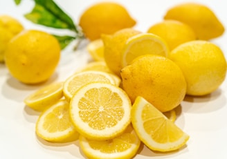 yellow lemon fruits on white surface